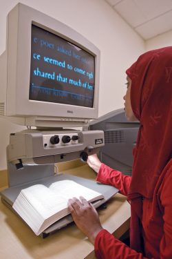 student reading enlarged text on display reader