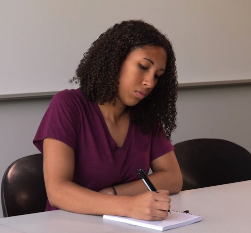 Woman taking notes at table