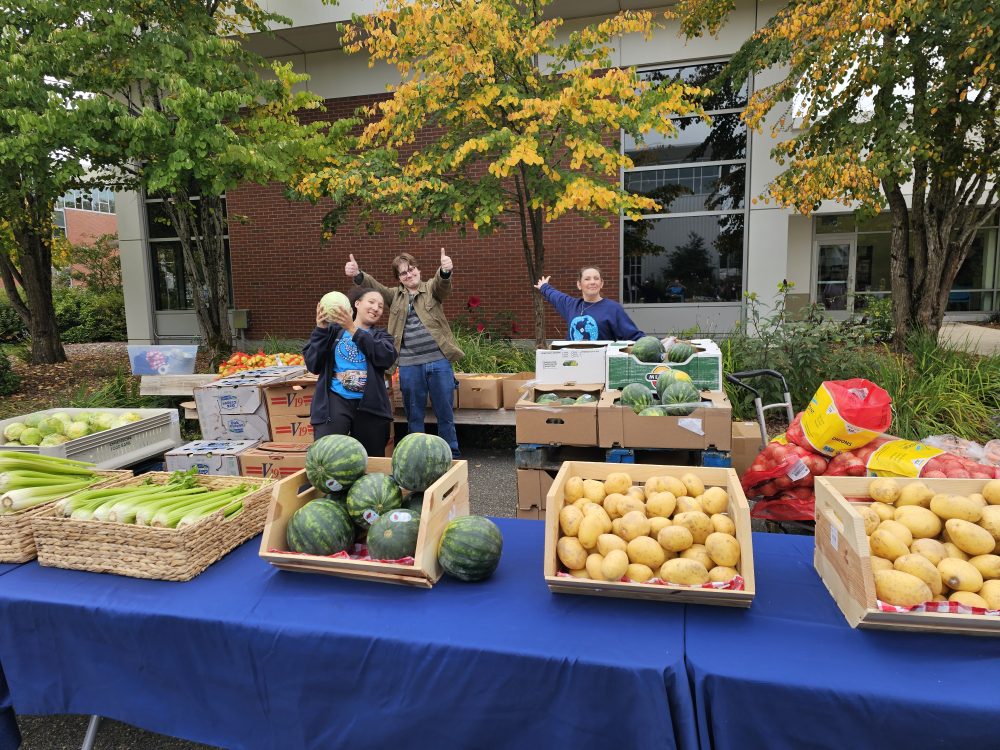 Photo of BNSL staff working at a free food market event