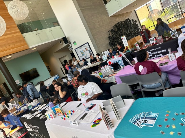 Photo of community partners tabling at a basic needs resource fair