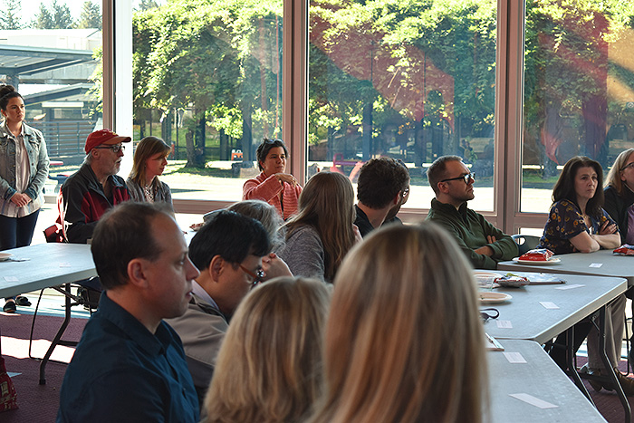 People sitting in a room listening to a speaker