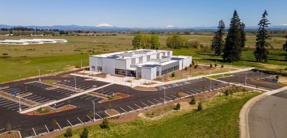 Aerial view of PCC Columbia County Center looking towards the northeast, showing the OMIC Training Center, parking lot and surrounding areas