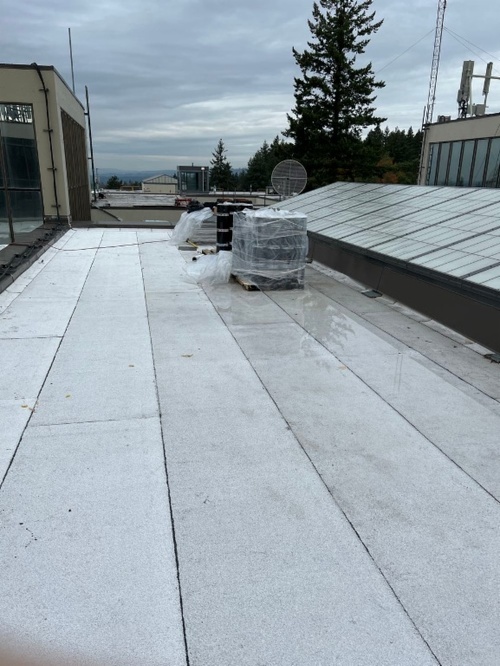 View of the College Center roof looking over other campus building tops and trees