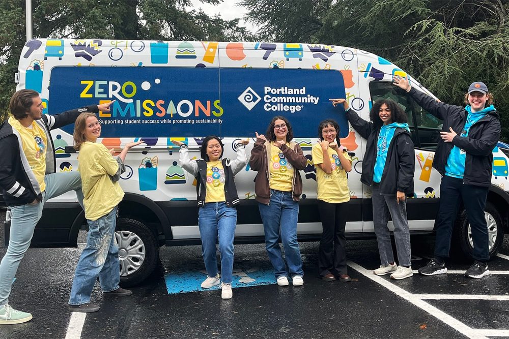 Staff in front of a PCC-branded EV van