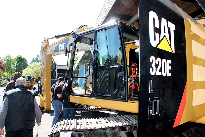 Students walking around large CAT machines