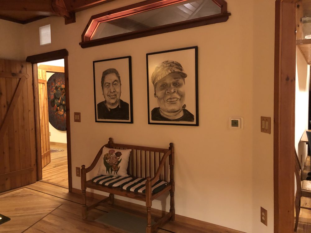 Two portraits by the PCC faculty decorating a corner of the house