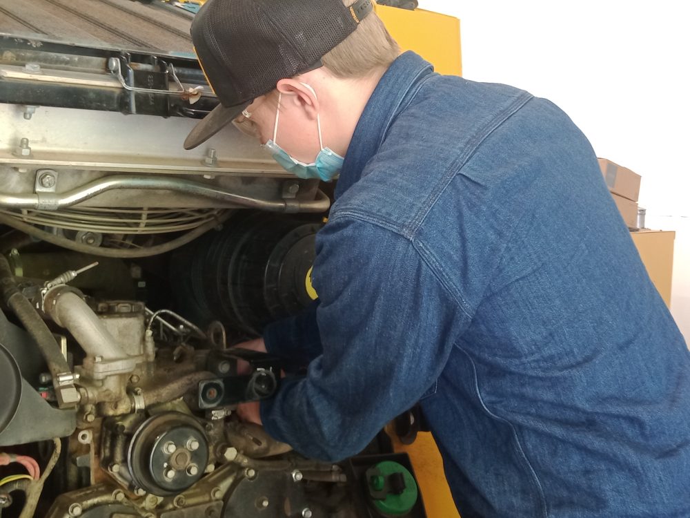 Student working on engine at the Dealer Service shop