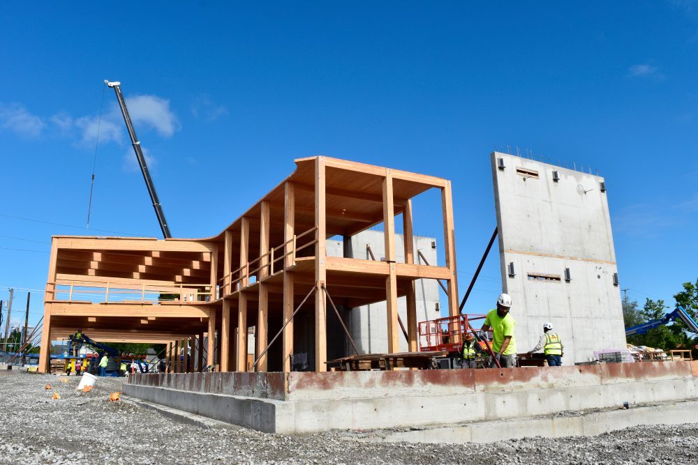 Construction site looking up towards the northwest, concrete structures along with recently installed timber frame