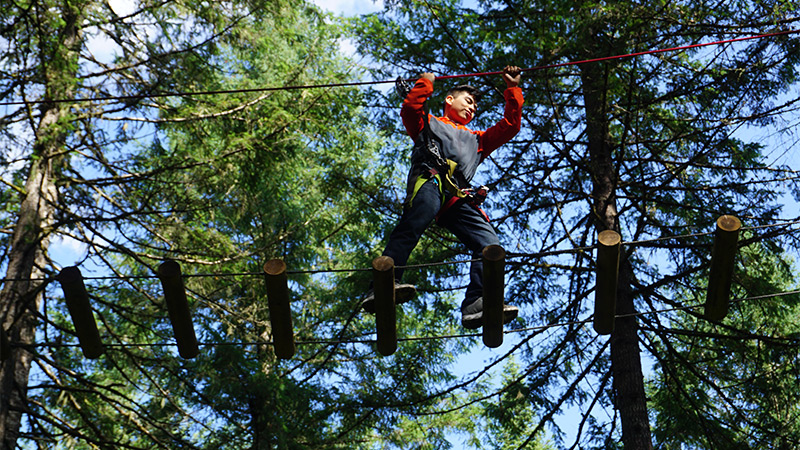 Student doing an outside obstacle course