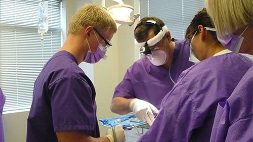 Student assisting in dental procedure