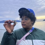 Dr. Nascimento holding a crab.