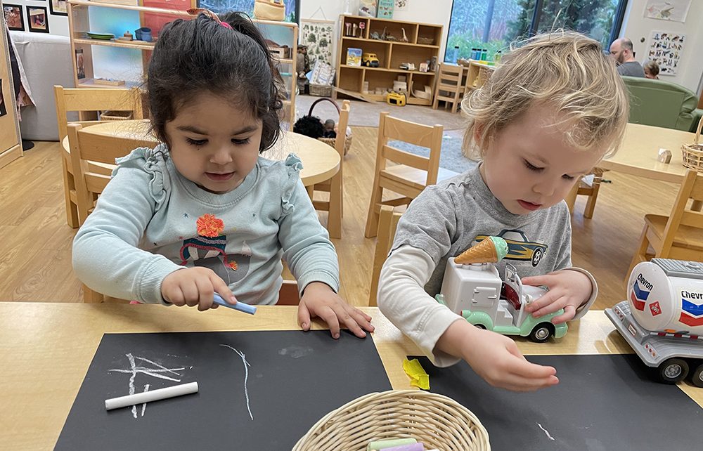 Two children drawing with chalk