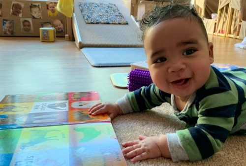 Smiling baby with a book