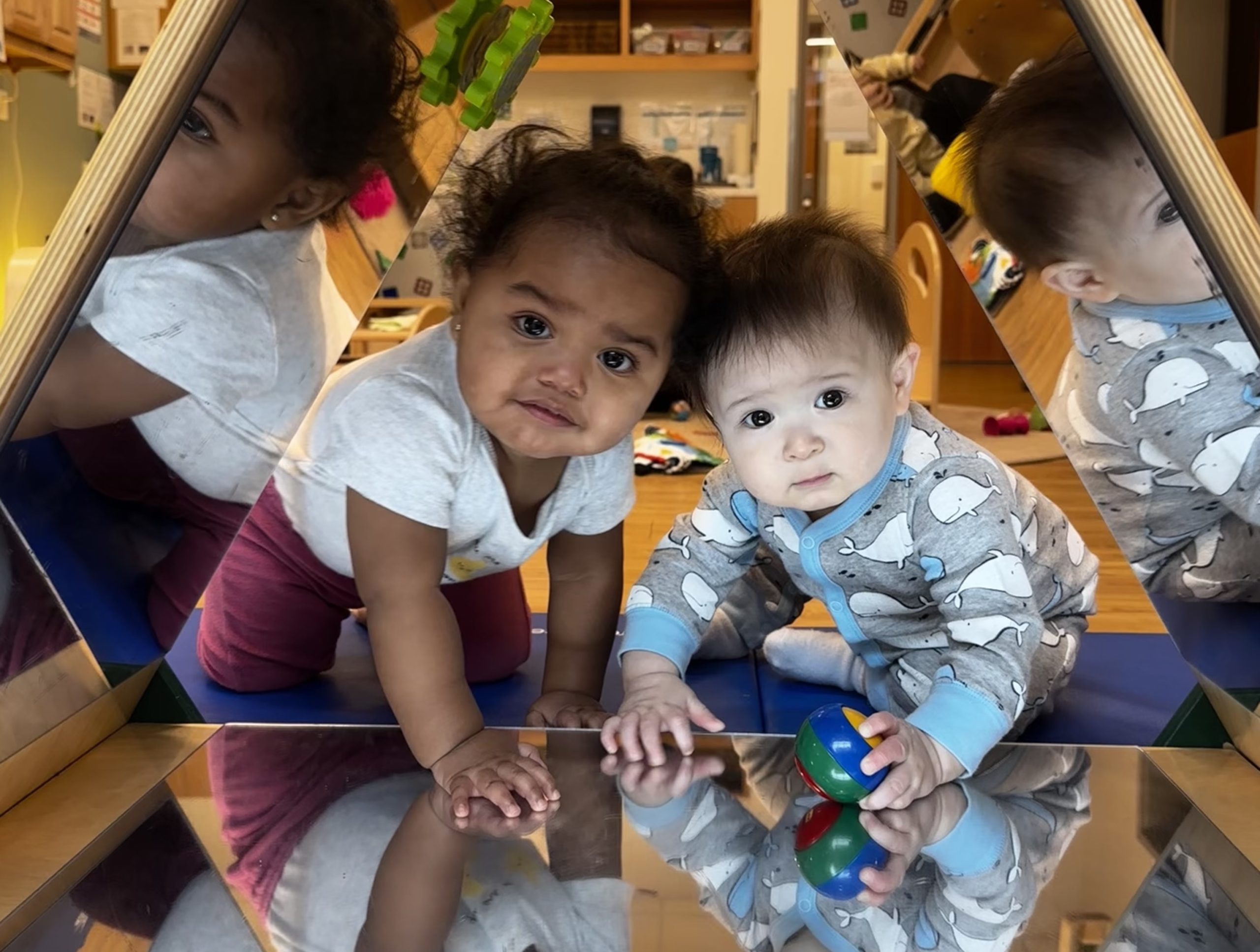 Two babies in a mirror tunnel