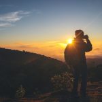 silhouette of photographer taking photo at sunset