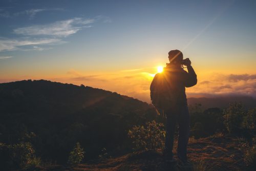 silhouette of photographer taking photo at sunset