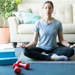 Woman Meditating and practicing yoga at home