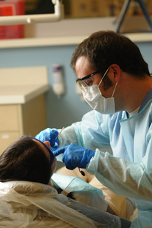 Dental student working with a patient