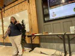 Denise Berkshire, the Forest Center Director, leads an educational workshop on the lifecycle of salmon inside the Forest Center's Community Hall.
