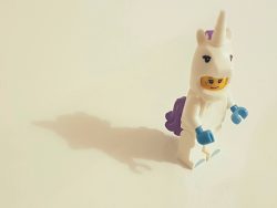 Photo of a lego figure in a unicorn outfit.