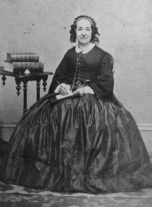 Black and white photo of Elizabeth Packard sitting in a large dress.