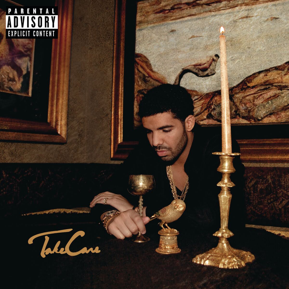 Album art depicts a young man (Drake) with light-medium skin tone dressed in a black dress shirt, wearing golden jewelry. He's sitting down at a table with golden items on it, in a room filled with brown paintings.