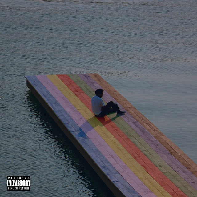 The Melodic Blue - Album art by Baby Keem depicts a person sitting on a rainbow painted dock jutting out into the water.