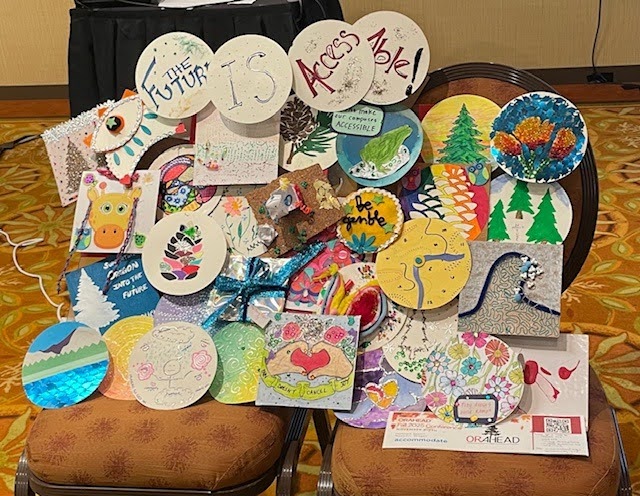 Collage of paper circles and squares with artwork depicting scenes, hearts, and animals. The 4 circles on top spell out "The Future is Access Able!"