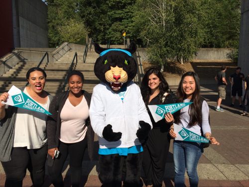 Group of high school students standing with PCC's mascot, Poppe the Panther