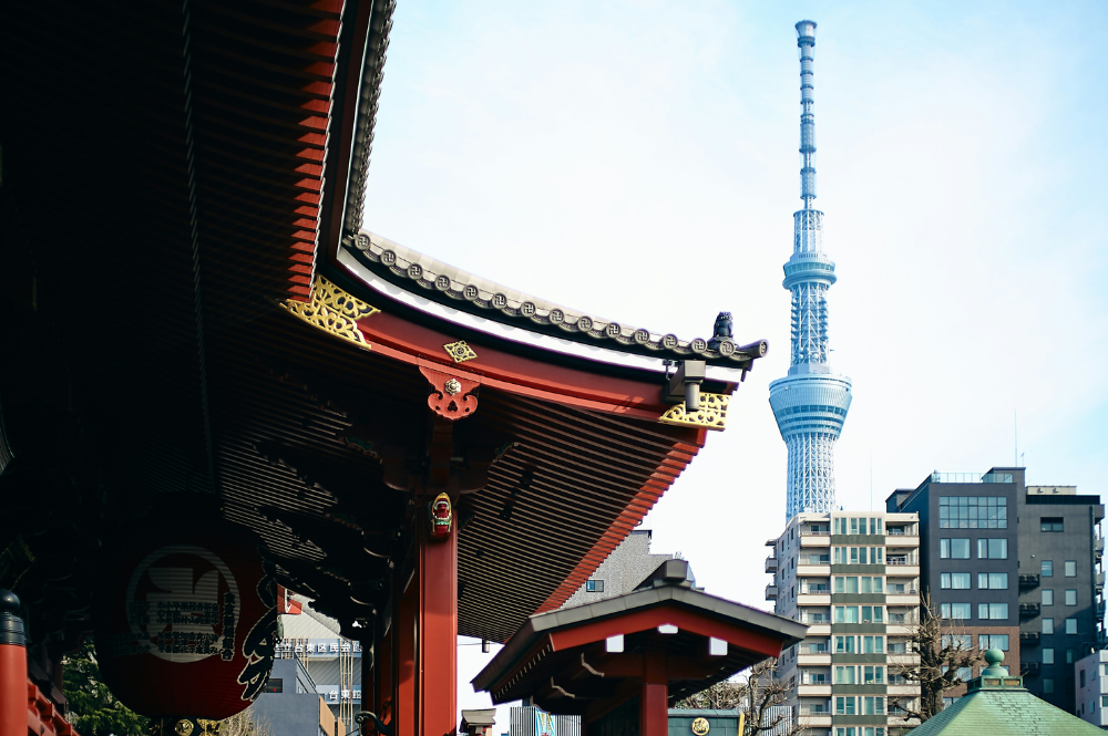 traditional temple with a modern tower in the background