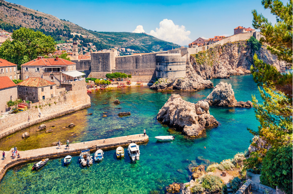 Croatia coastline with a castle wall and boats