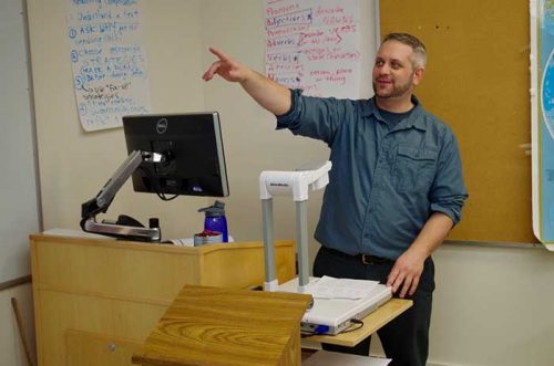 teacher standing in front of the podium