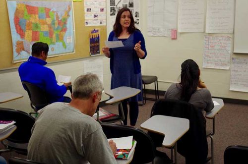 teacher speaking in front of the class