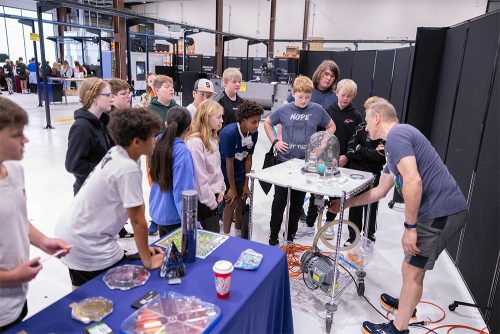 Students at MFG Day using equipment and watching instructors