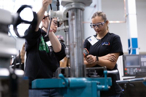 Students at MFG Day using equipment and watching instructors