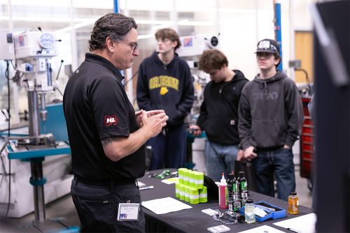 Students at MFG Day using equipment and watching instructors