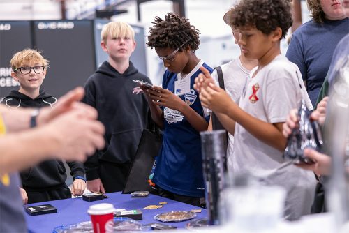 Students at MFG Day using equipment and watching instructors