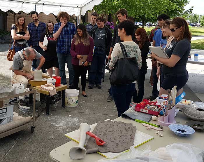 man giving a demonstration on a potter wheel