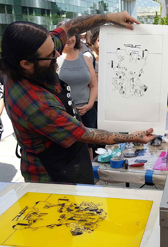 man holding up a black and white print