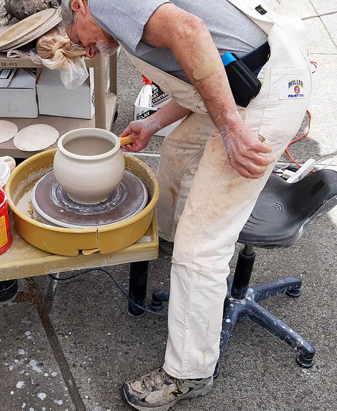 man working on pottery wheel