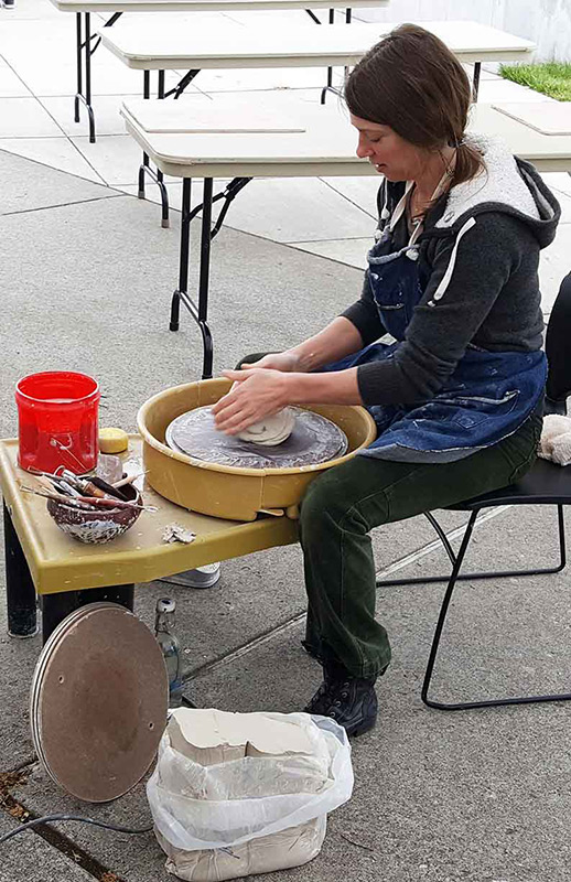 woman working on pottery wheel