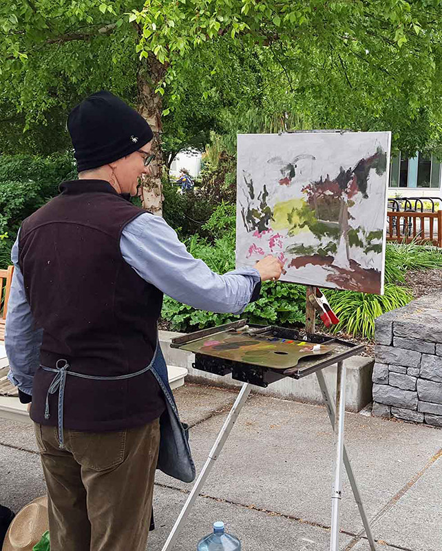 woman painting at an easel