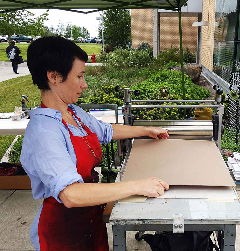 woman using a printing press