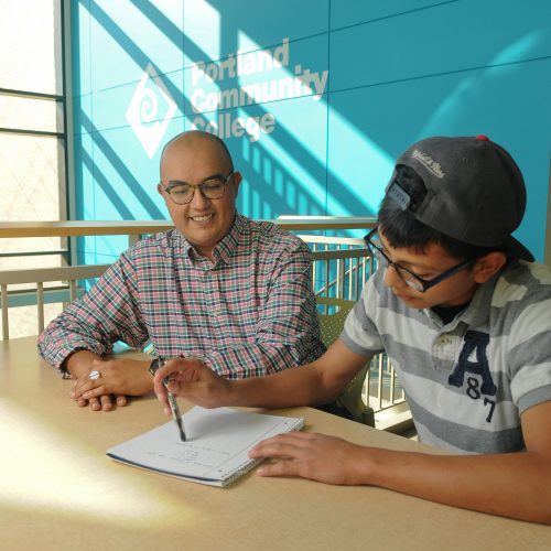 PCC staff and student work together on assignment in sunny study area