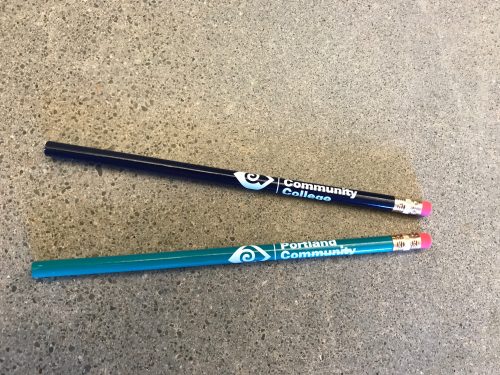 Black or turquoise pencils with a white PCC logo