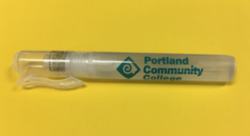Clear hand sanitizer tube with a turquoise PCC logo and clip