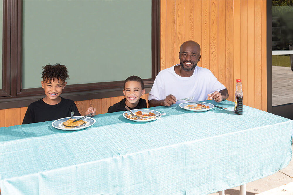 Sylvester eating pancakes with his sons