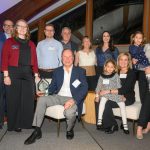 A group of people smiling at camera.