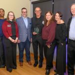 A group of people smiling at camera.