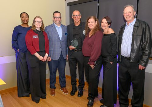 A group of people smiling at camera.